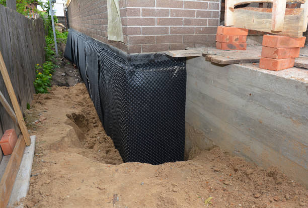 SJ Waterproofing Pros technician performing targeted Wet Basement Repair assessment in Taylorsville, IN
